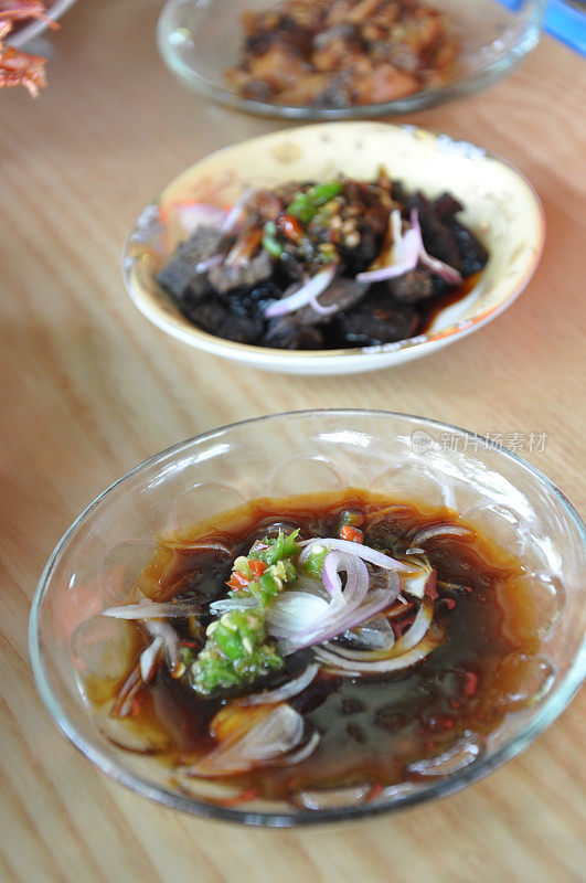 Indonesian soy sauce with sliced ​​shallots and green chilies served on small plate